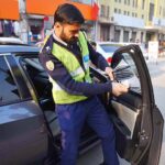 Traffic Warden Officials are removing tinted sheet from a car at Cantt Bazar.