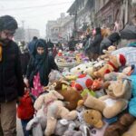 People selecting and purchasing old toys from vendor