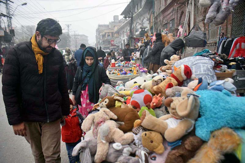 People selecting and purchasing old toys from vendor