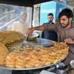 Vendor are busy in preparing and selling traditional Saltish item at his roadside setup.