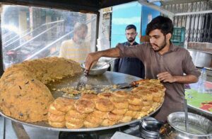 Vendor are busy in preparing and selling traditional Saltish item at his roadside setup. 