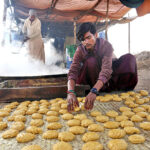 A worker preparing traditional sweet item Gur at Mirpurkhas road.