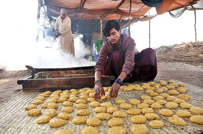 A worker preparing traditional sweet item Gur at Mirpurkhas road.