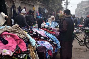 People selecting and purchasing old toys from vendor