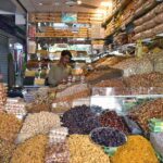 A vendor selling dry fruits at his shop as per increased demand in winter season in a local market of Provincial City.