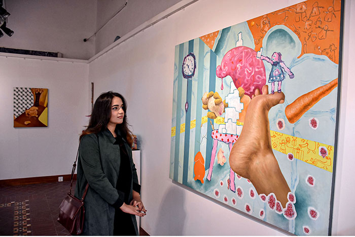 Visitors viewing the displayed paintings and Arts work during the Bachelor and Master of Visual Art Artists exhibition (Degree Show 2023) at National College of Arts.