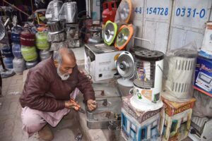 Worker repairing Gas stove at his workshop