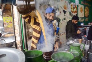 Vendor preparing tea for customers at his shop in the Hashtnagri area.