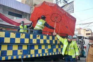 Traffic police officials removing encroachment during a drive launched on the instructions of Chief Traffic Officer Dr. Zahid ullah at Fawara Chowk.