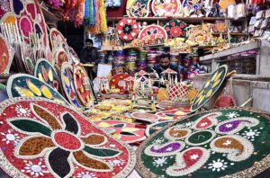 A vendor preparing the different kinds of decorative stuff using during marriage ceremonies at his workplace. 