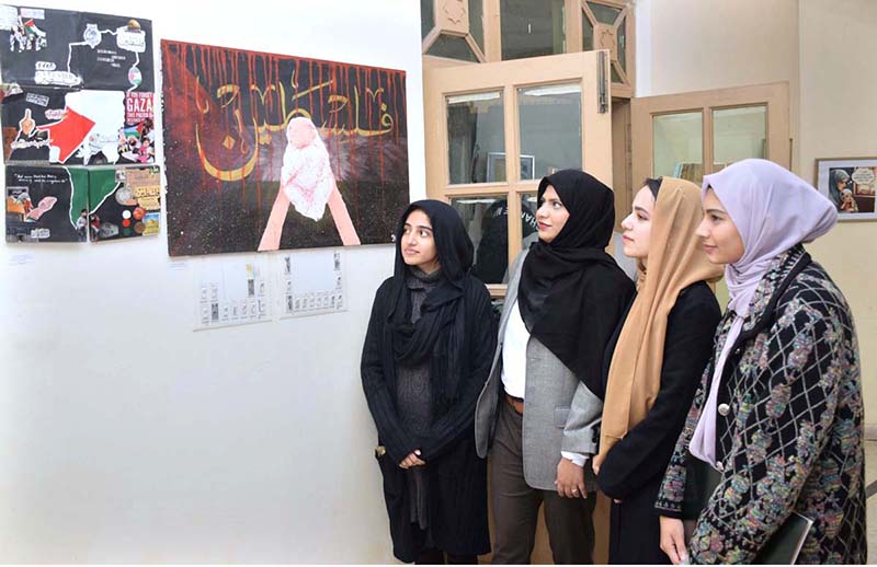 Visitor viewing the painting during Painting Exhibition “Palestine Live Matter” Art and Design Exhibition at Naseem Hafeez Qazi Gallery at Lahore College for Women University