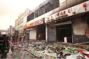Rescue officials engage in fire extinguishing operation in Time Center mobile market at Saddar area