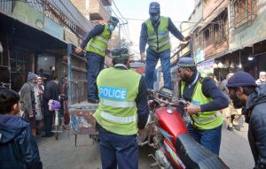 Traffic police officials removing encroachment during a drive launched on the instructions of Chief Traffic Officer Dr. Zahid ullah at Fawara Chowk.