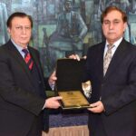 Secretary Senate, Mohammad Qasim Samad Khan presenting a shield to Director General (Translation) Senate Secretariat, Muhammad Usman on his retirement from Senate Secretariat at Parliament House.