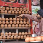 A vendor is busy in displaying Matka tea cups to attract the customers at Anarkali market.