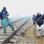 Railway staffers busy in maintenance work of railway tracks near Railway Station