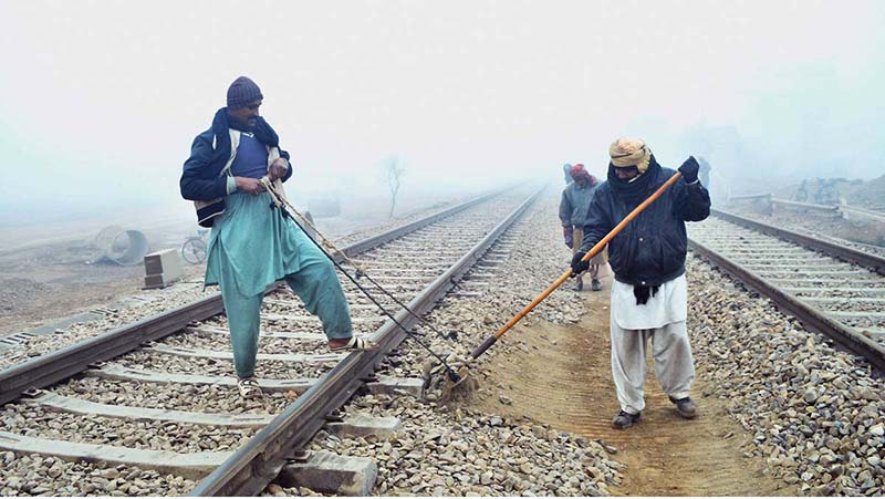 Railway staffers busy in maintenance work of railway tracks near Railway Station