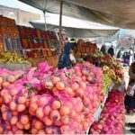 A vendor displaying oranges to attract the customers at his roadside setup in Federal Capital
