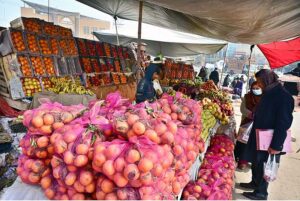 A vendor displaying oranges to attract the customers at his roadside setup in Federal Capital