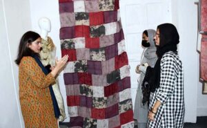 Visitors viewing creative work during 18th Annual Degree Show at SABS University of Art, Design and Heritages Jamshoro.