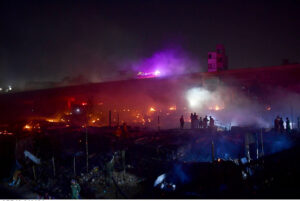 Fire fighters extinguish fire erupted in the makeshift homes at Teen Hatti slum area.