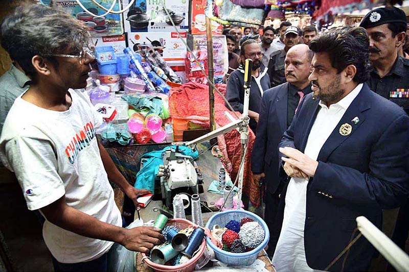 Governor Sindh Kamran Tessori talking with shopkeeper during his visit Shama Shopping Center and Resham Bazaar of Shah Faisal Colony