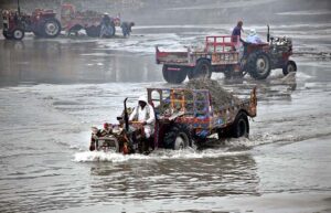 Tractor trolley loaded with river sand one of the fine sand used in concrete and masonry work, passing through Rice Canal. 