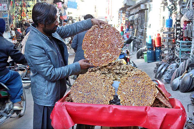 A vendor displaying sweets (lahi) to attract customers