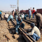 Railway workers are repairing a railway track near Railway Station