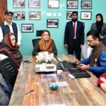 Begum Samina Arif Alvi being briefed during her visit to Roshni Helpline office.