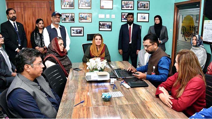 Begum Samina Arif Alvi being briefed during her visit to Roshni Helpline office.