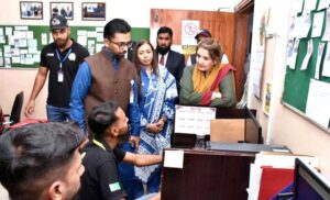Begum Samina Arif Alvi being briefed during her visit to Roshni Helpline office.
