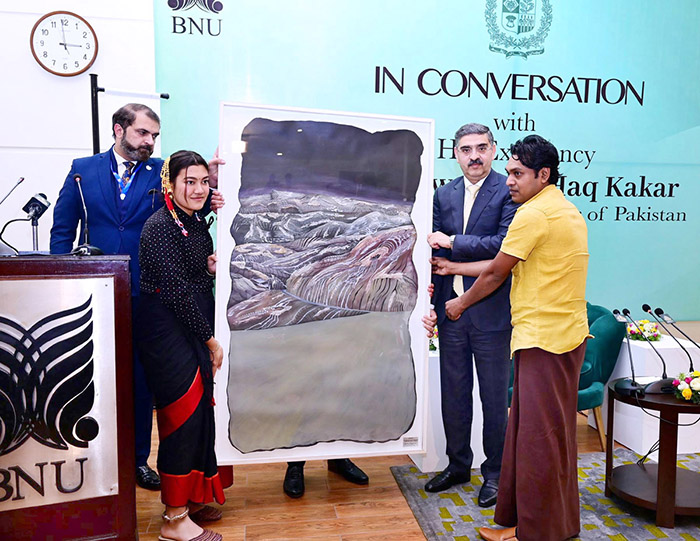 Students of BNU present Caretaker Prime Minister Anwaar-ul-Haq Kakar with a painting as a souvenir.