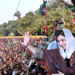Leader of People’s Party, Miss Asfa Bhutto Zardari responding to the workers' slogans by waving hand during election campaign in public meeting at Shahpur Rizi Village.