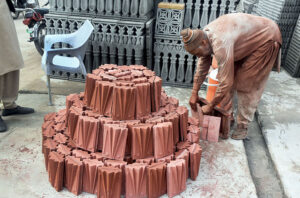 Labourer busy displaying tuff tiles at IJP Road in the Federal Capital.
