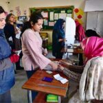 A woman casts her vote in the polling station during General Election-2024