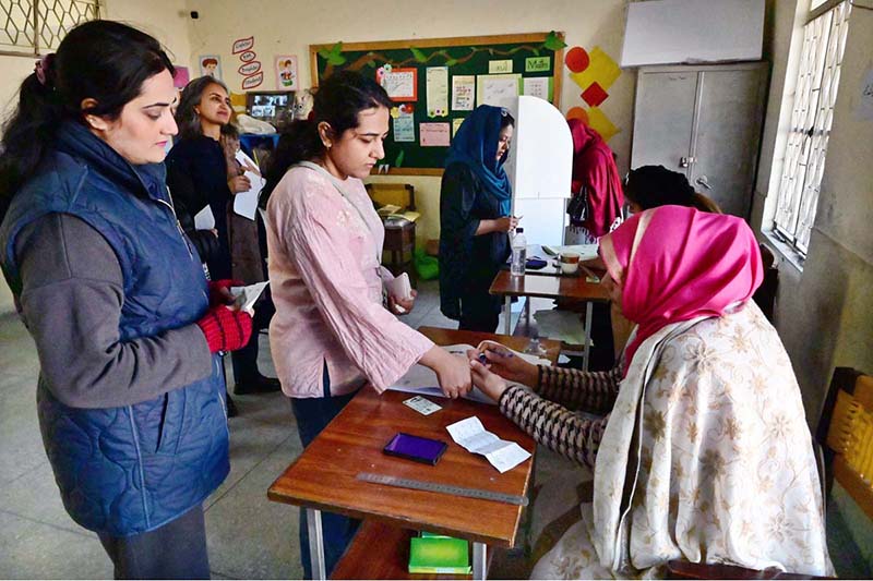 A woman casts her vote in the polling station during General Election-2024