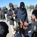 A large number of people in queue to get free food at G-11.