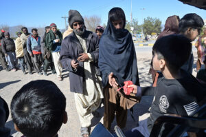 A large number of people in queue to get free food at G-11.