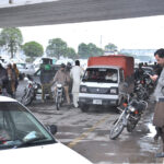 Commuters getting shelter under the bridge to avoid the rain that experienced in the city
