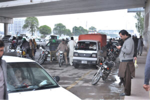 Commuters getting shelter under the bridge to avoid the rain that experienced in the city