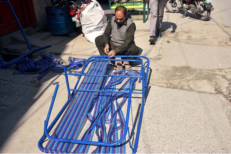 Artisan busy making wooden bench at Banni Chowk