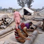Workers busy welding iron pipe at IJP Road in the Federal Capital.