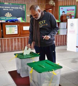 A woman casts her vote in the polling station during General Election-2024