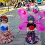 Vendors arranging and displaying shoes on handcart to attract the customers at Murree Road
