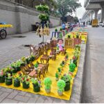 A vendor displaying artificial items on roadside footpath to attract customers at Marrir Chowk.
