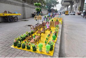 A vendor displaying artificial items on roadside footpath to attract customers at Marrir Chowk.