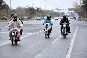 Commuters getting shelter under the bridge to avoid the rain that experienced in the city