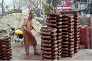 Labourer busy in making tuff tiles at IJP Road in the Federal Capital.