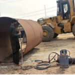 Workers busy welding iron pipe at IJP Road in the Federal Capital.